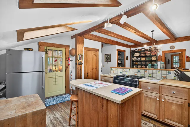 a kitchen with a refrigerator a stove and a sink