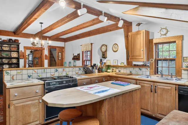 a kitchen with a sink a stove and cabinets