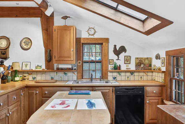 a kitchen with a sink and a stove top oven