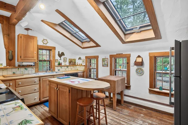 a open kitchen with stainless steel appliances granite countertop a stove and wooden floors