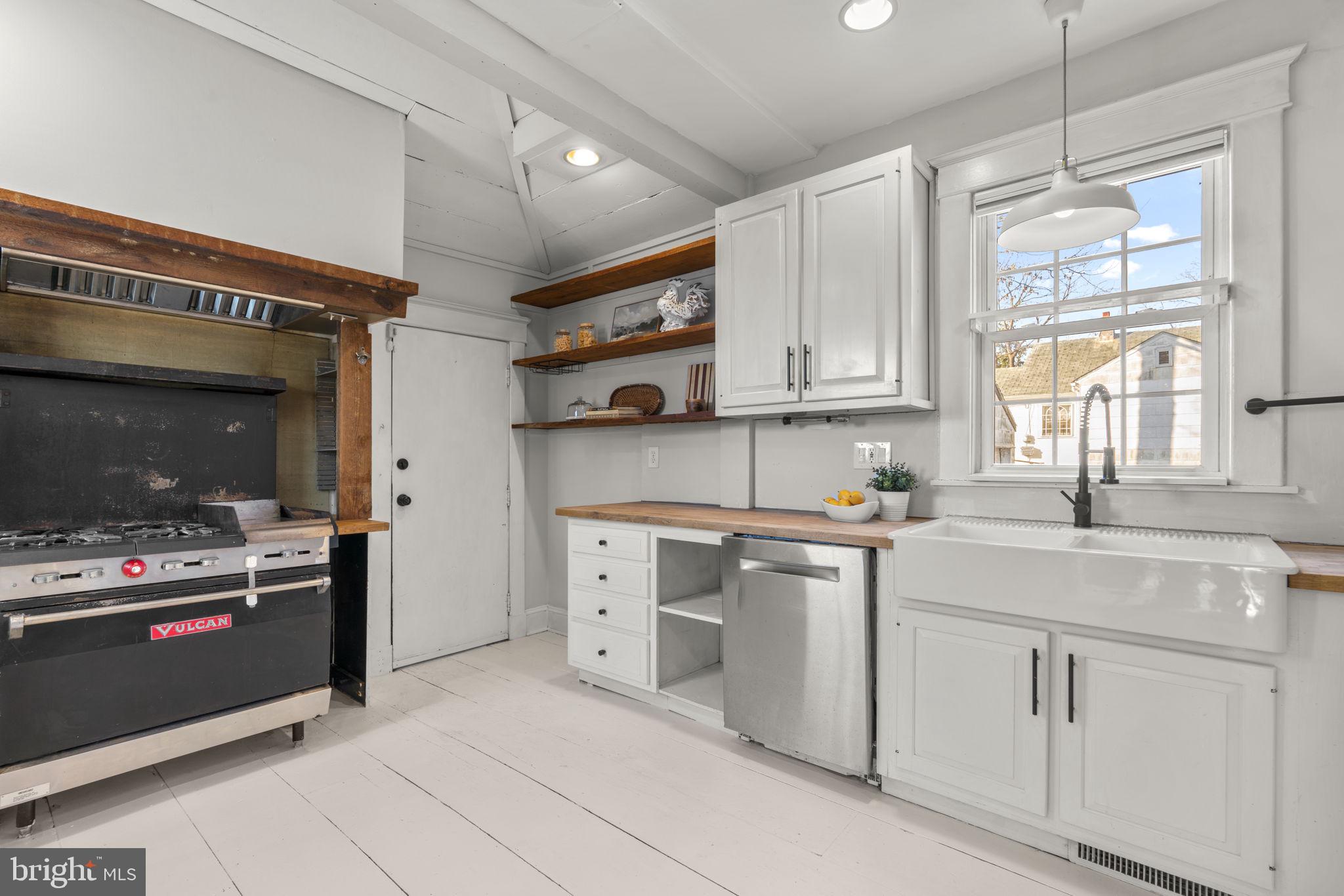 4413 Hooper Avenue Baltimore, MD 21229 - Photo 13 of 33 Kitchen with wood floor, open shelving