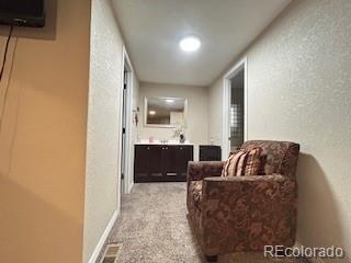 7115 Harold Street, Unit 2 Fort Lupton, CO 80621 - Photo 11 of 27 a living room with furniture and a flat screen tv