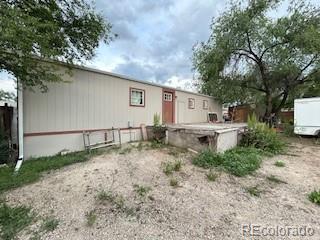 7115 Harold Street, Unit 2 Fort Lupton, CO 80621 - Photo 21 of 27 a white house that has a tree in front of it