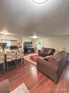 7115 Harold Street, Unit 2 Fort Lupton, CO 80621 - Photo 4 of 27 a living room with furniture and a fireplace