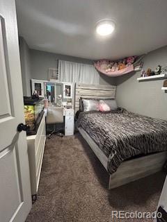 7115 Harold Street, Unit 2 Fort Lupton, CO 80621 - Photo 6 of 27 a bedroom with a bed a couch and dresser