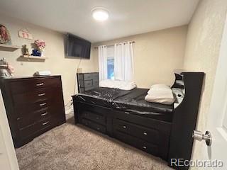 7115 Harold Street, Unit 2 Fort Lupton, CO 80621 - Photo 9 of 27 a room with a dresser and a window