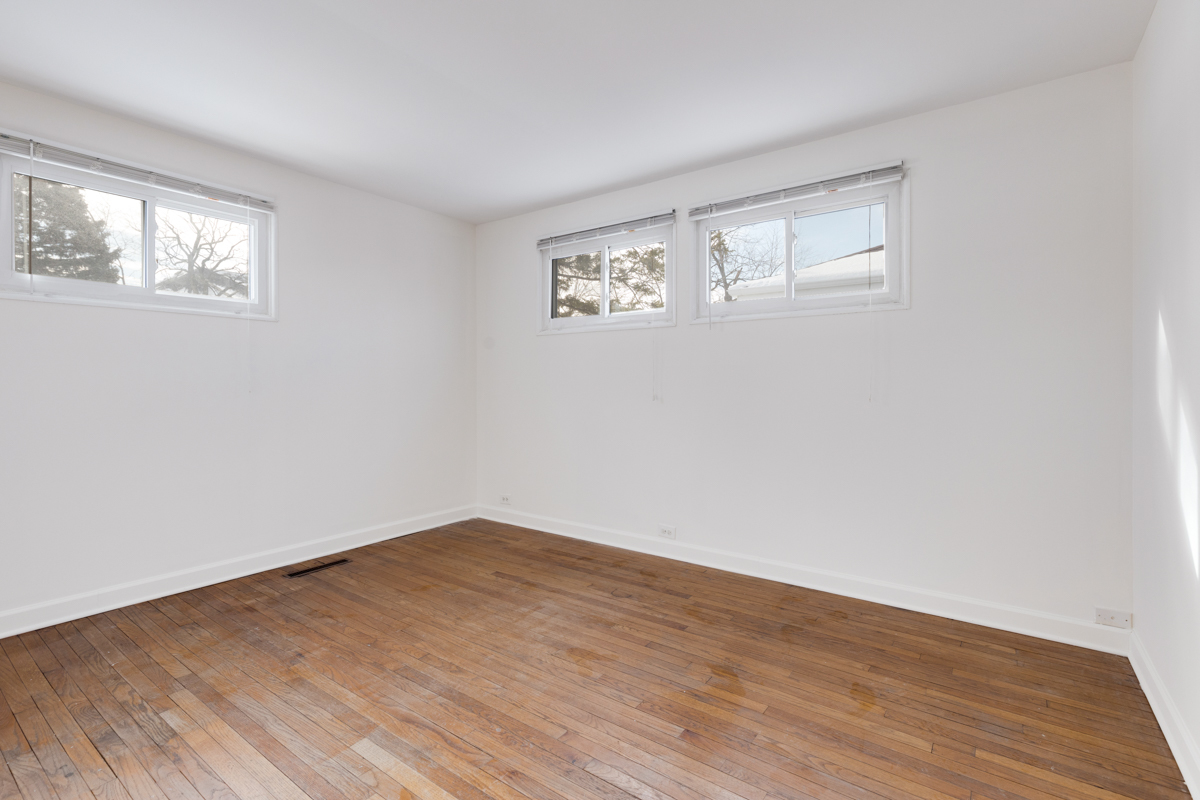 9432 Sayre Avenue Morton Grove, IL 60053 - Photo 11 of 20 a view of empty room with wooden floor and fan