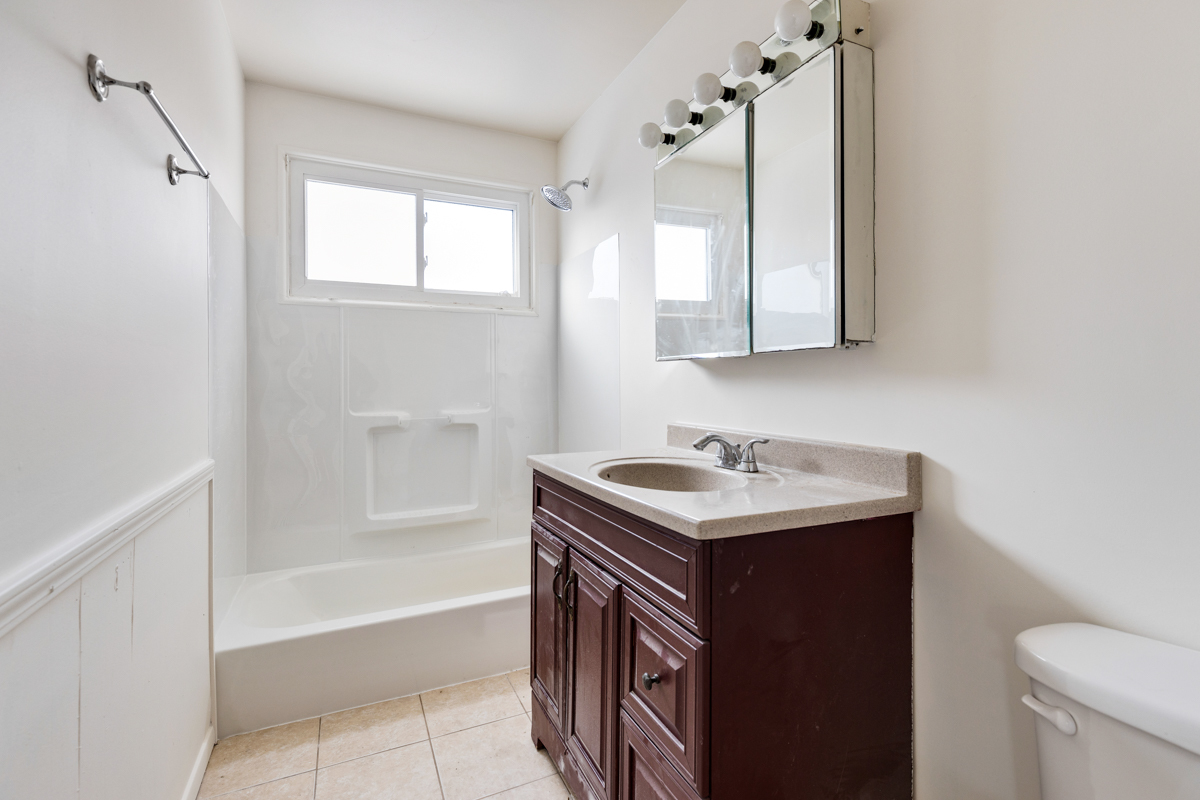 9432 Sayre Avenue Morton Grove, IL 60053 - Photo 12 of 20 a bathroom with a sink a toilet and shower