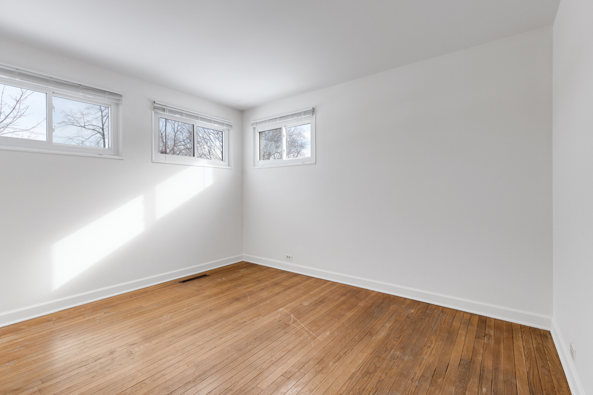 9432 Sayre Avenue Morton Grove, IL 60053 - Photo 13 of 20 an empty room with wooden floor and windows
