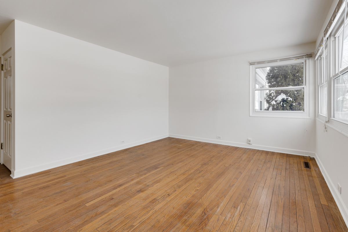 9432 Sayre Avenue Morton Grove, IL 60053 - Photo 14 of 20 an empty room with wooden floor and windows