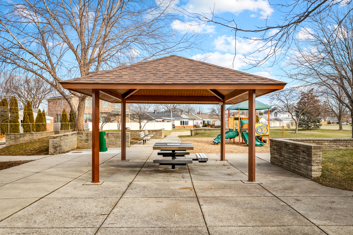 9432 Sayre Avenue Morton Grove, IL 60053 - Photo 18 of 20 a view of patio with table and chairs under an umbrella