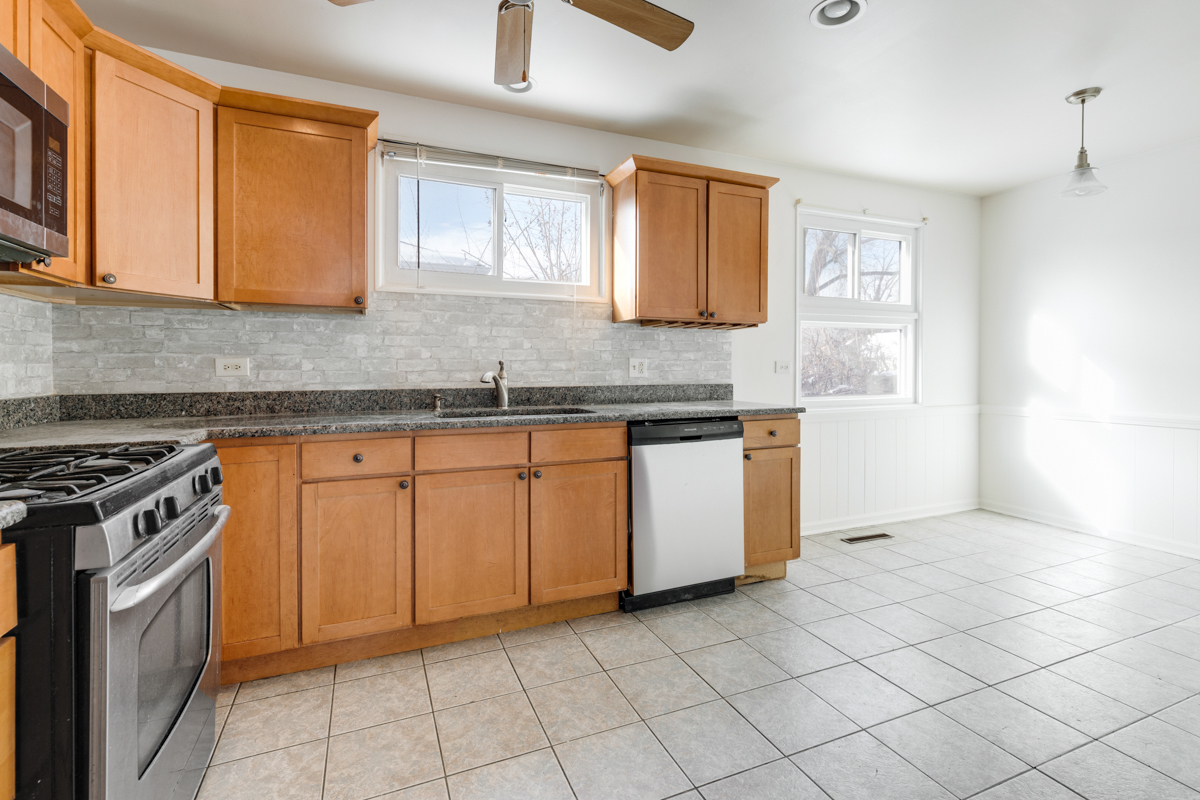 9432 Sayre Avenue Morton Grove, IL 60053 - Photo 7 of 20 a kitchen with a stove sink and cabinets