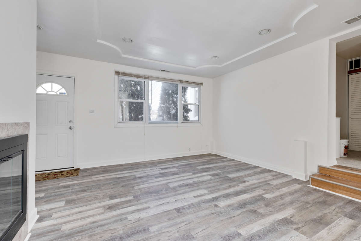 9432 Sayre Avenue Morton Grove, IL 60053 - Photo 9 of 20 a view of an empty room with wooden floor and a window
