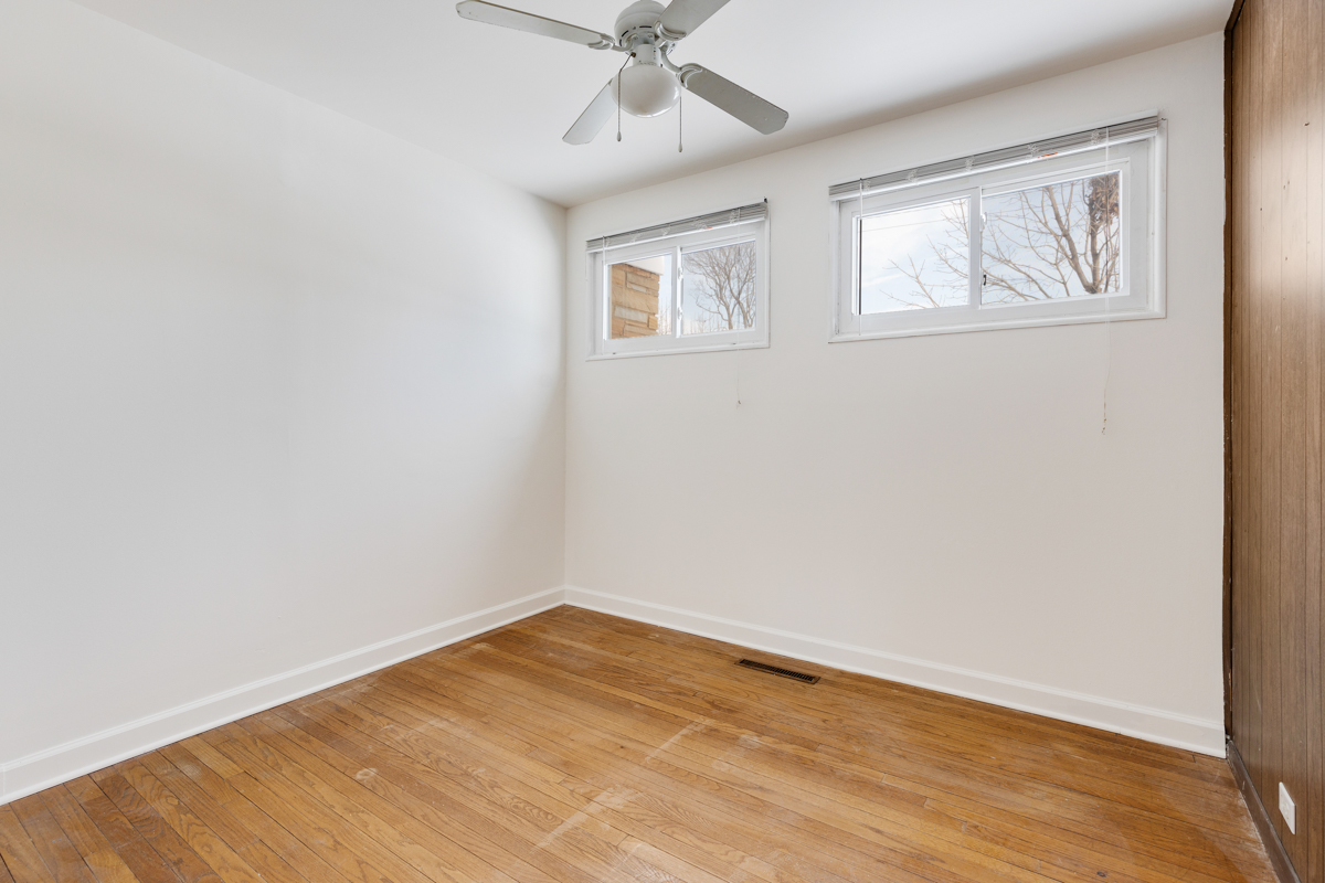 9432 Sayre Avenue Morton Grove, IL 60053 - Photo 10 of 20 an empty room with a window and wooden floor