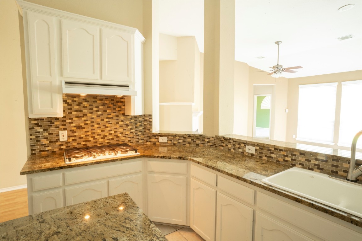 1712 Hackney Cove Austin, TX 78727 - Photo 11 of 38 a bathroom with a granite countertop sink and a mirror