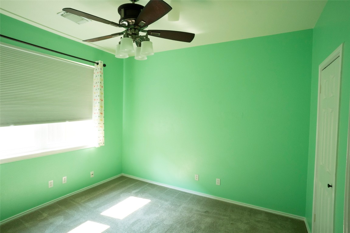 1712 Hackney Cove Austin, TX 78727 - Photo 24 of 38 a room with a window and a ceiling fan