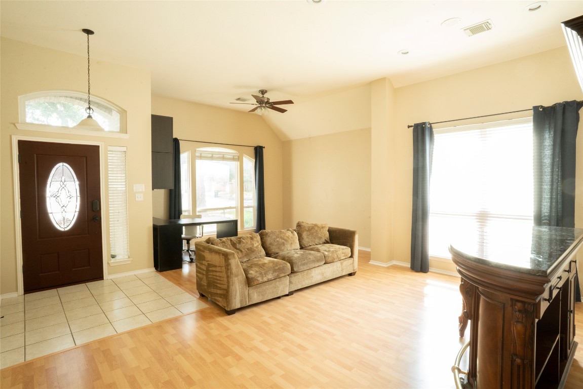 1712 Hackney Cove Austin, TX 78727 - Photo 26 of 38 a living room with furniture a window and a fireplace