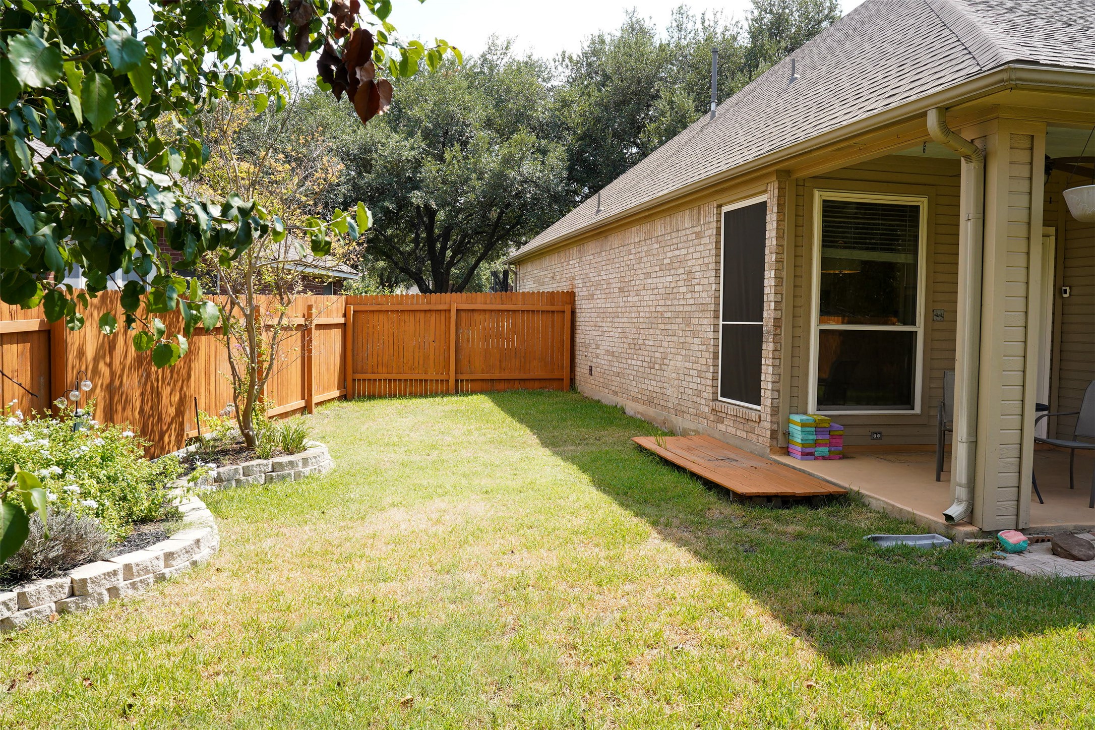 1712 Hackney Cove Austin, TX 78727 - Photo 32 of 38 a view of a backyard with table and chairs and potted plants