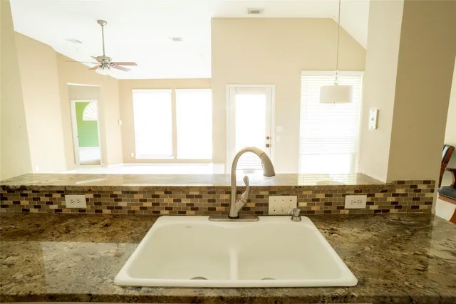 a bathroom with a tub sink and window