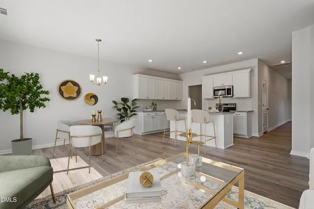 a living room with furniture and kitchen view