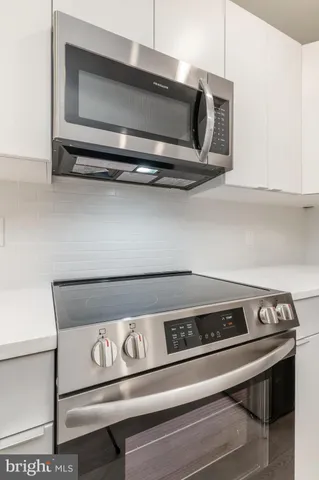 a stove top oven sitting inside of a kitchen