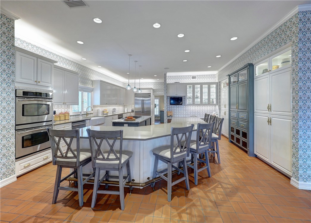 334 Pebble Beach Drive Portland, TX 78374 - Photo 11 of 40 a kitchen with a dining table chairs and refrigerator