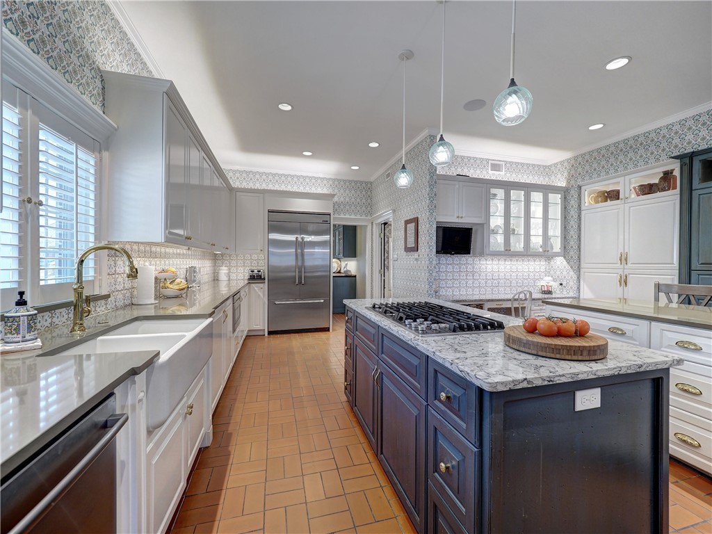 334 Pebble Beach Drive Portland, TX 78374 - Photo 12 of 40 a kitchen with stainless steel appliances granite countertop a stove a sink dishwasher and a refrigerator