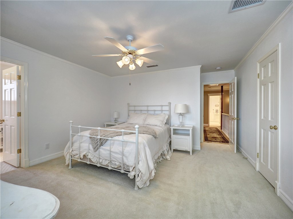334 Pebble Beach Drive Portland, TX 78374 - Photo 39 of 40 a spacious bedroom with a bed and a chandelier