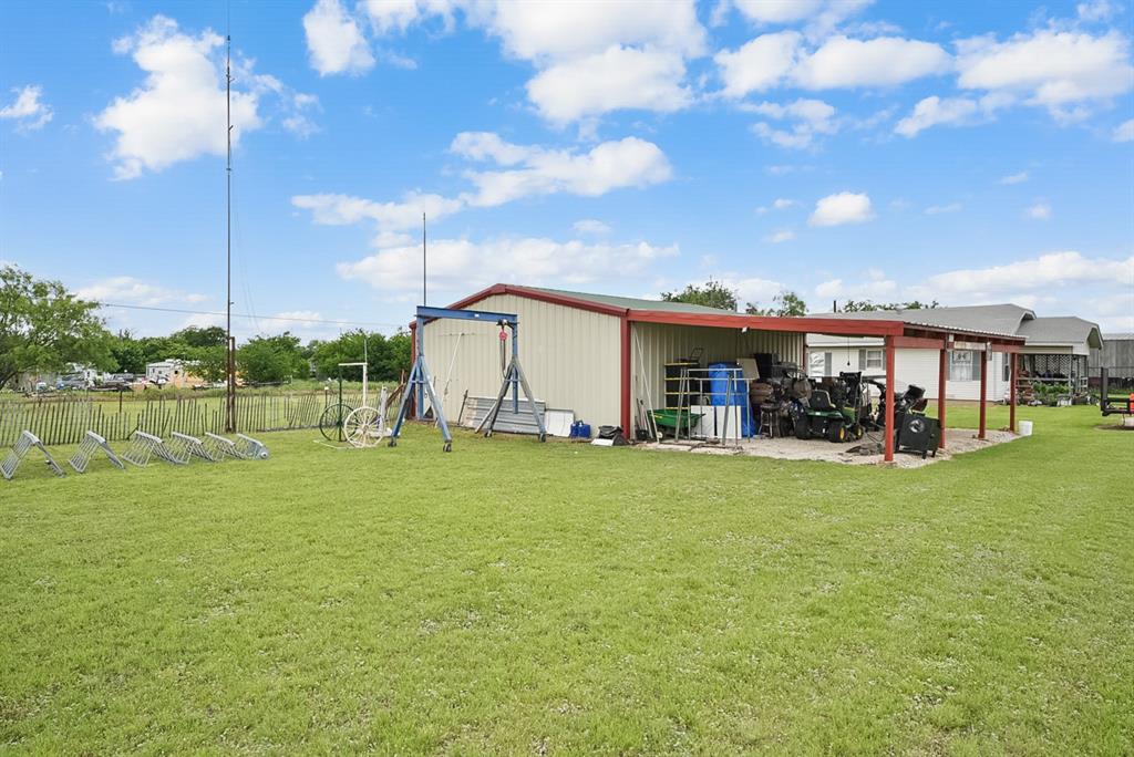 4948 Tin Top Road Weatherford, TX 76087 - Photo 17 of 24 a view of a house with a big yard and a large tree