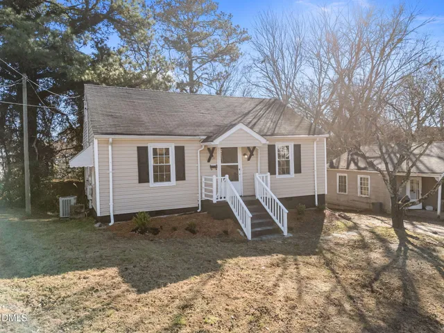 a view of a house with a yard covered in snow