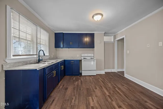 a kitchen with wooden floors and sink