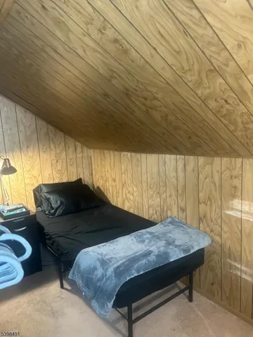 a bedroom with a bed window and couch