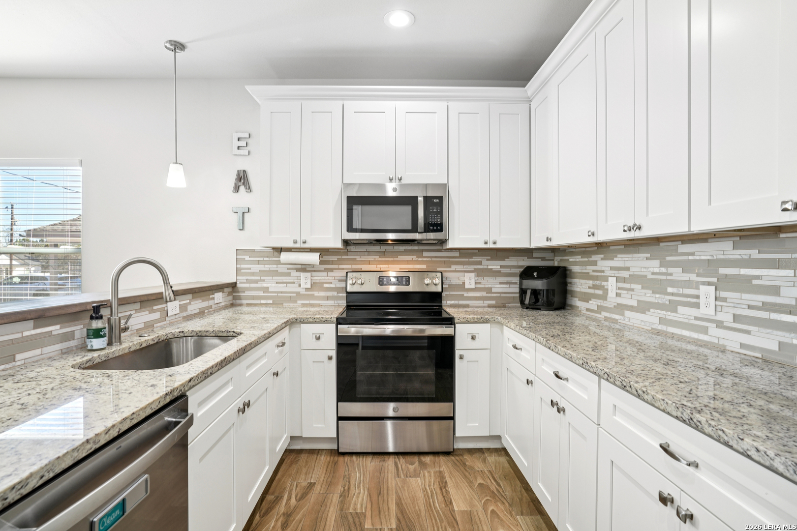 156 Remington Road Spring Branch, TX 78070 - Photo 12 of 32 a kitchen with stainless steel appliances granite countertop a stove sink and cabinets