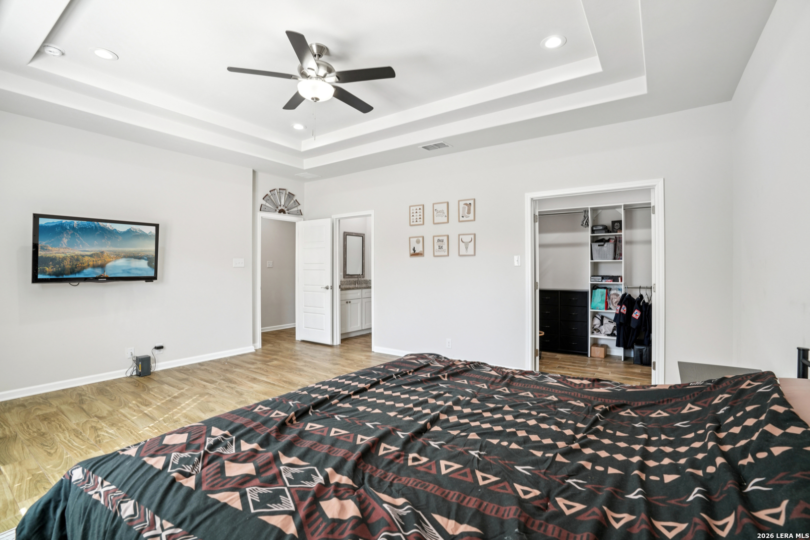 156 Remington Road Spring Branch, TX 78070 - Photo 15 of 32 a bedroom with a bed and a chandelier