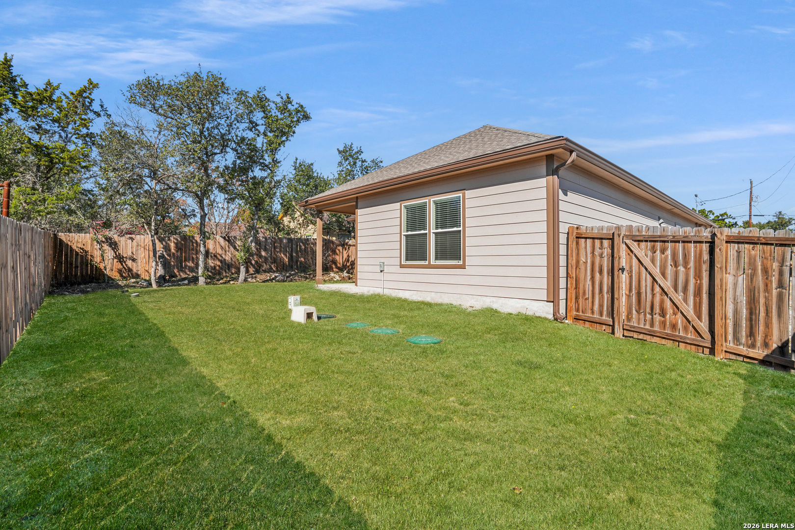 156 Remington Road Spring Branch, TX 78070 - Photo 27 of 32 a backyard of a house with plants and large tree