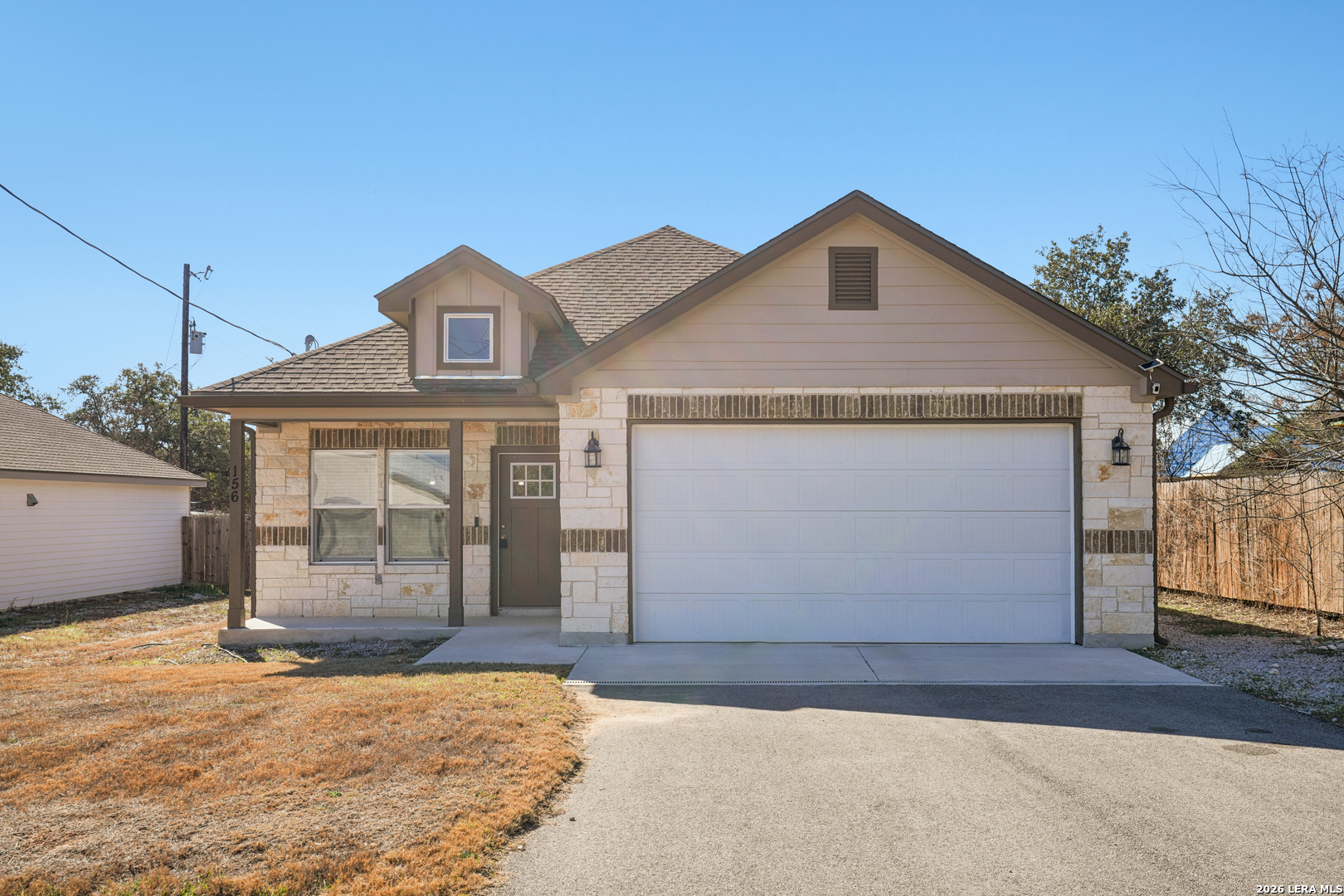 156 Remington Road Spring Branch, TX 78070 - Photo 3 of 32 a front view of a house with a yard and garage