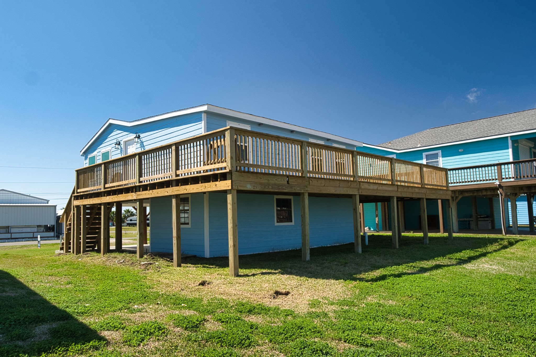 976 County Road 201 Sargent, TX 77414 - Photo 2 of 40 Wrap-around deck on 3 sides of the home for plenty of leisure space!
