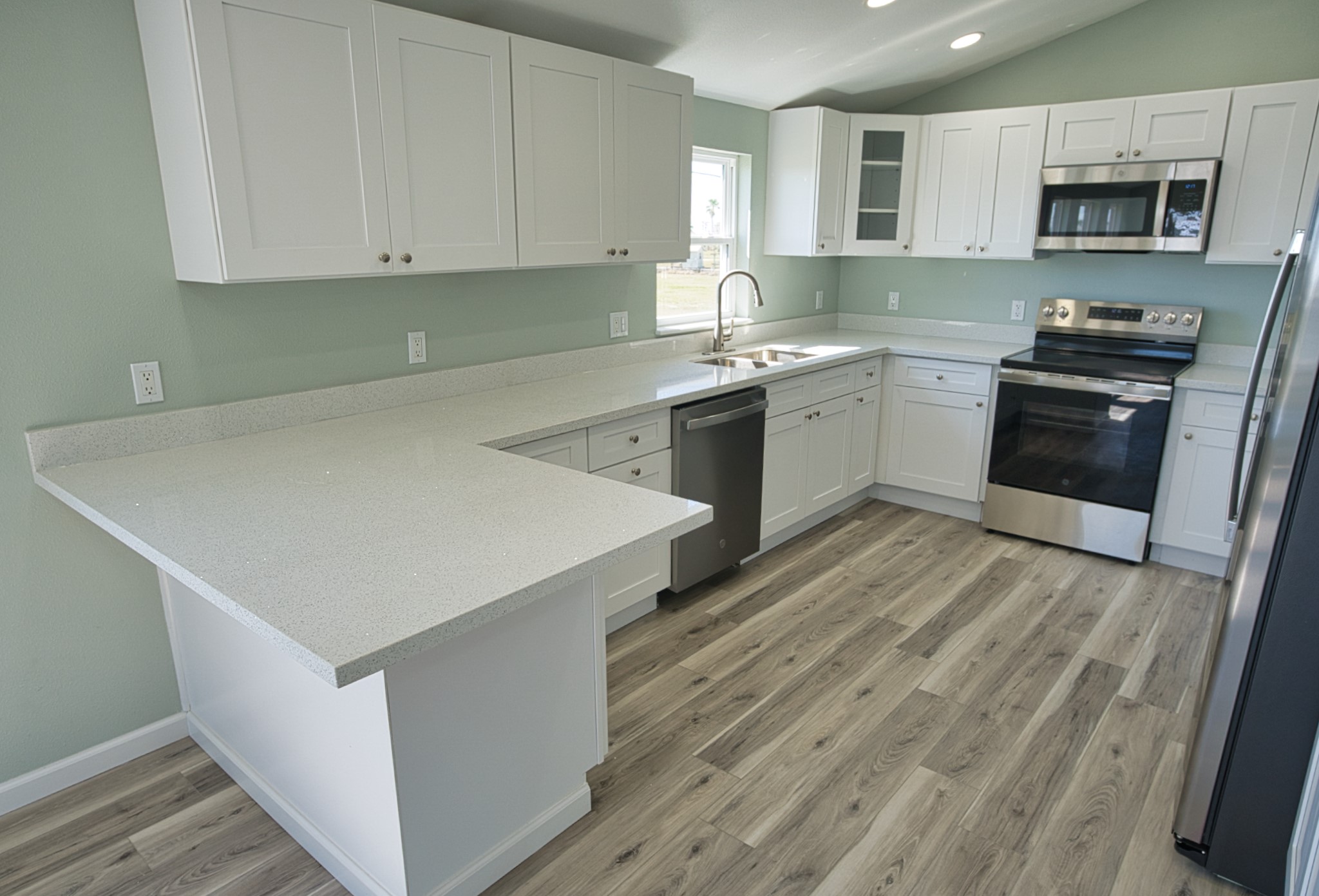 976 County Road 201 Sargent, TX 77414 - Photo 10 of 40 Upgraded granite countertops, solid plywood cabinets with soft close doors/drawers and all stainless steel appliances in this kitchen!