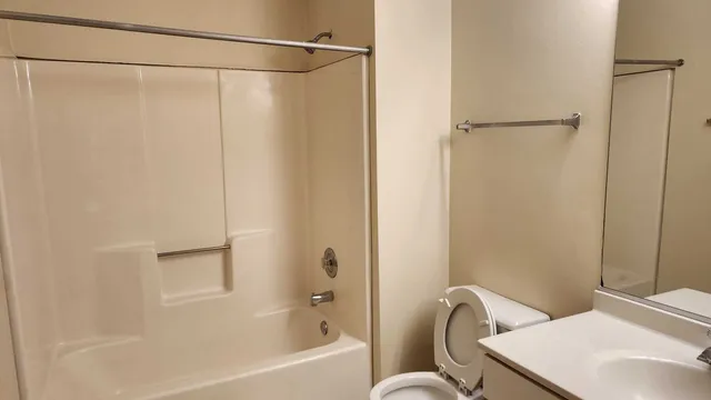 a bathroom with a shower curtain and a sink