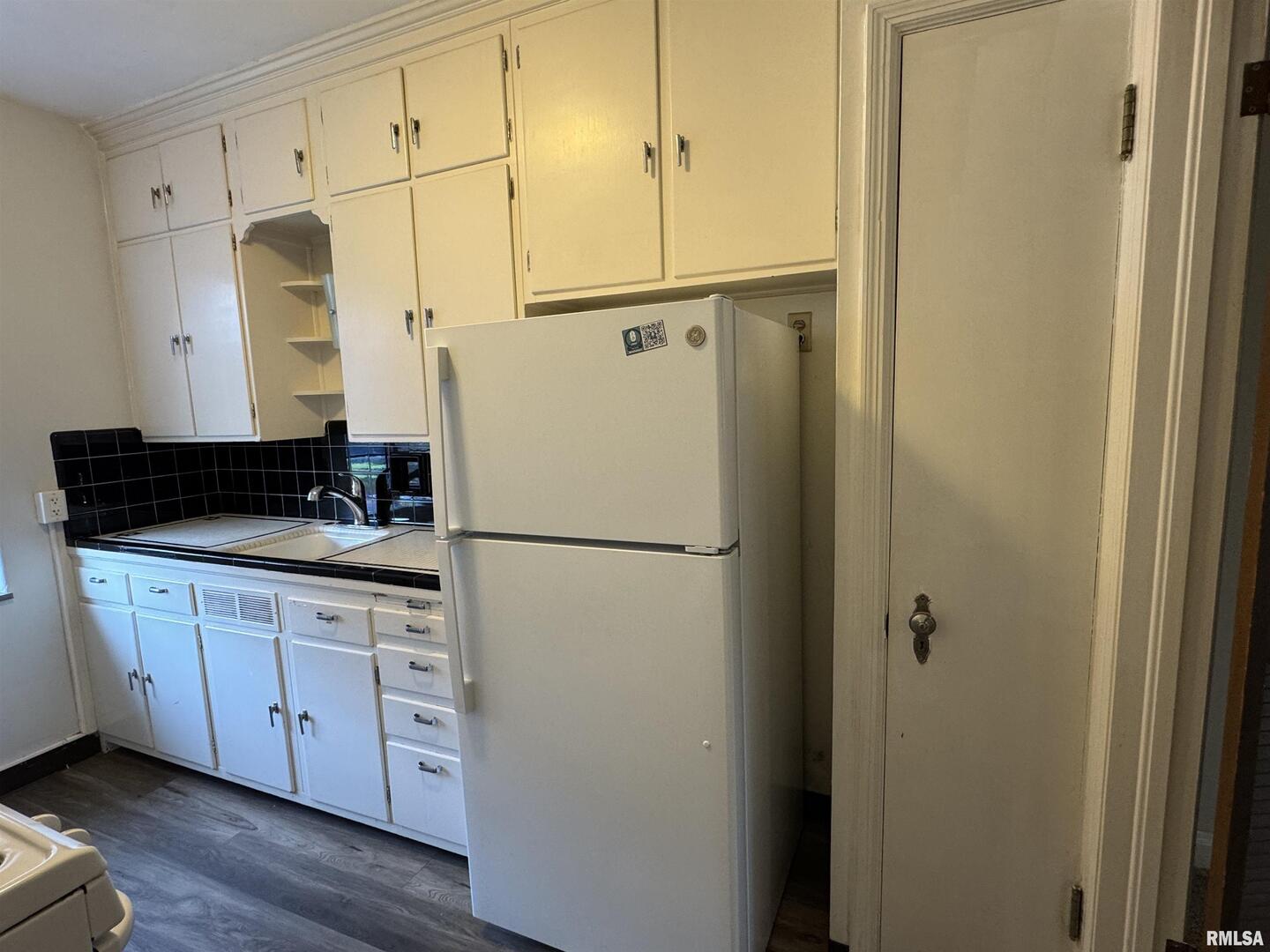 405 West Columbia Avenue, Unit 6 undefined, IA 52803 - Photo 11 of 12 a white refrigerator freezer sitting in a kitchen