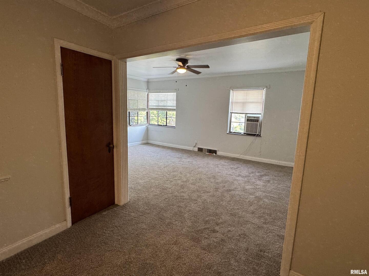 405 West Columbia Avenue, Unit 6 undefined, IA 52803 - Photo 7 of 12 an empty room with windows and ceiling fan
