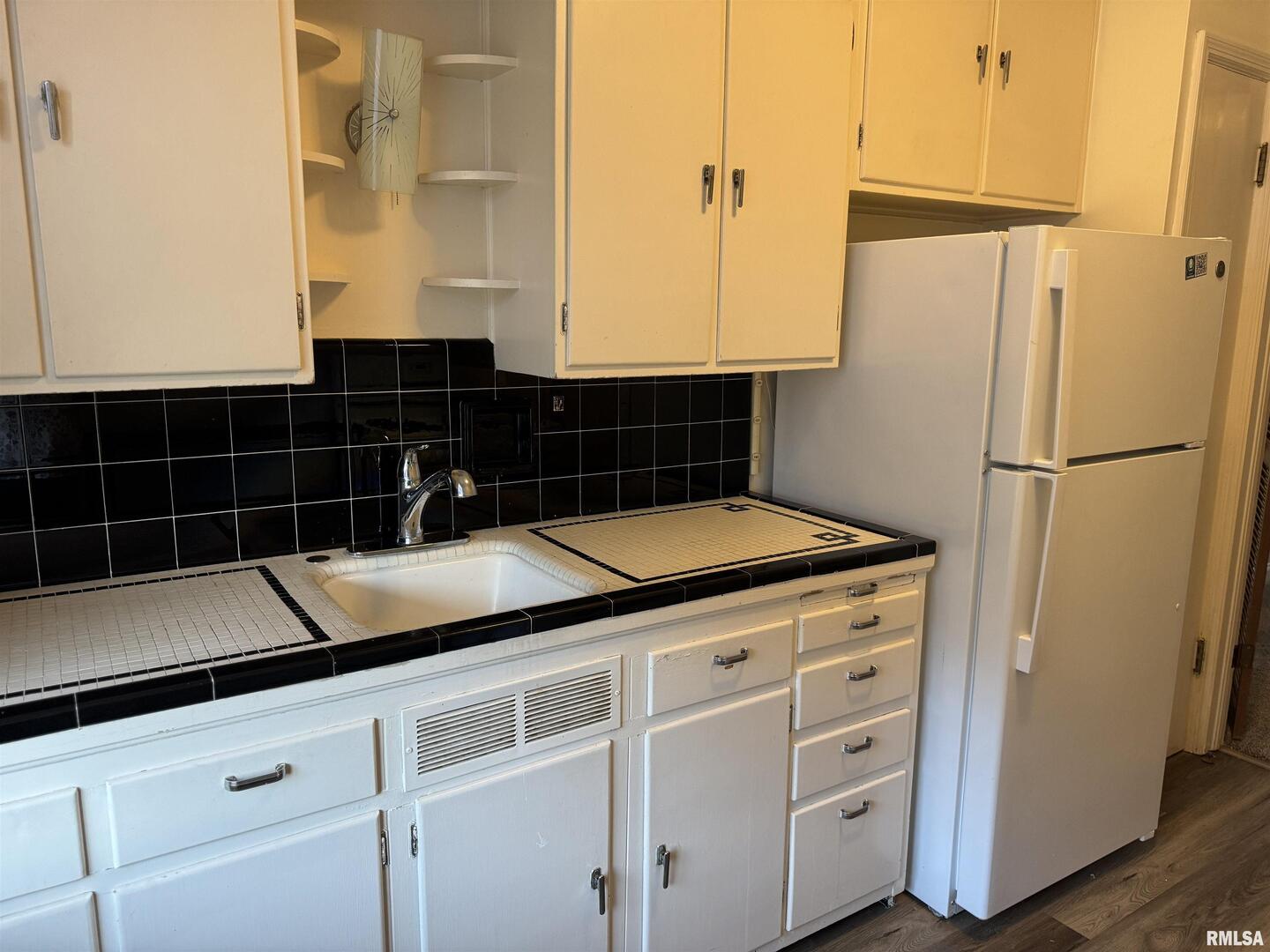 405 West Columbia Avenue, Unit 6 undefined, IA 52803 - Photo 10 of 12 a kitchen with appliances cabinets and a counter top space