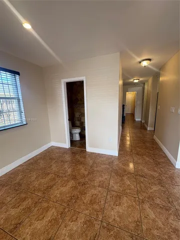 a view of kitchen with stainless steel appliances a refrigerator and window