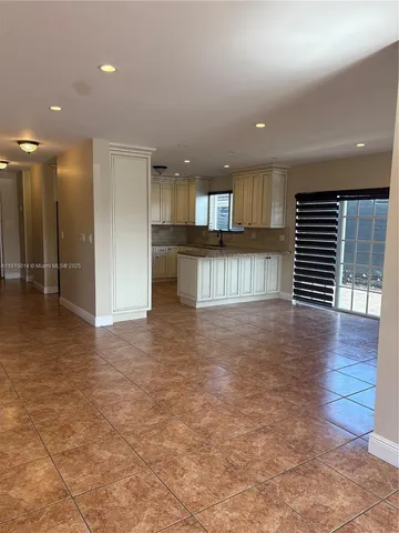 a kitchen with stainless steel appliances granite countertop a refrigerator sink and cabinets