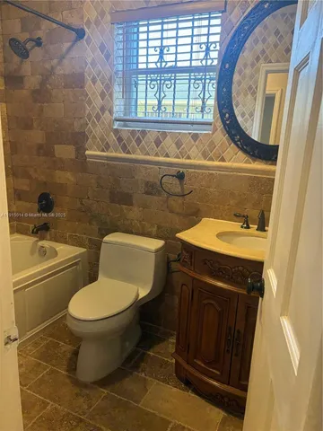 view of a hallway with wooden floor and closet