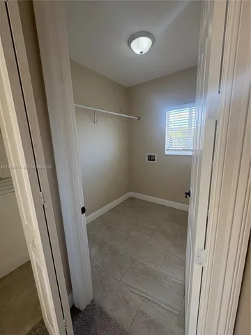 an empty room with windows and entrance