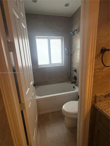 a view of walk in closet with racks on the wall