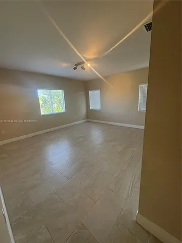 a large bathroom with a large mirror vanity and shower