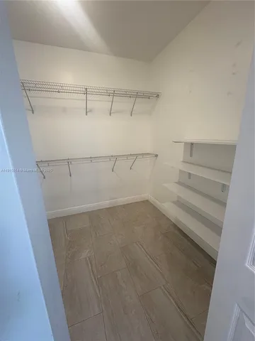 a white toilet sitting next to a bathroom sink and a window
