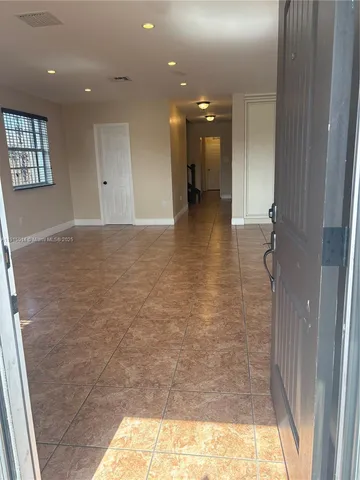 a view of a big room with kitchen and windows